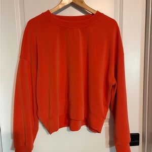 Lululemon Vibrant Orange Sweatshirt. Crop style fit, hits at waist.